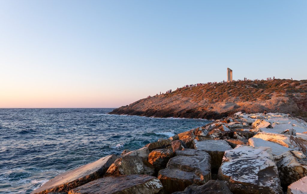Breakwater of Palatia (with the Temple of Apollo and people watching the sunset in the background), Chora, Naxos, Greece julesvernex2