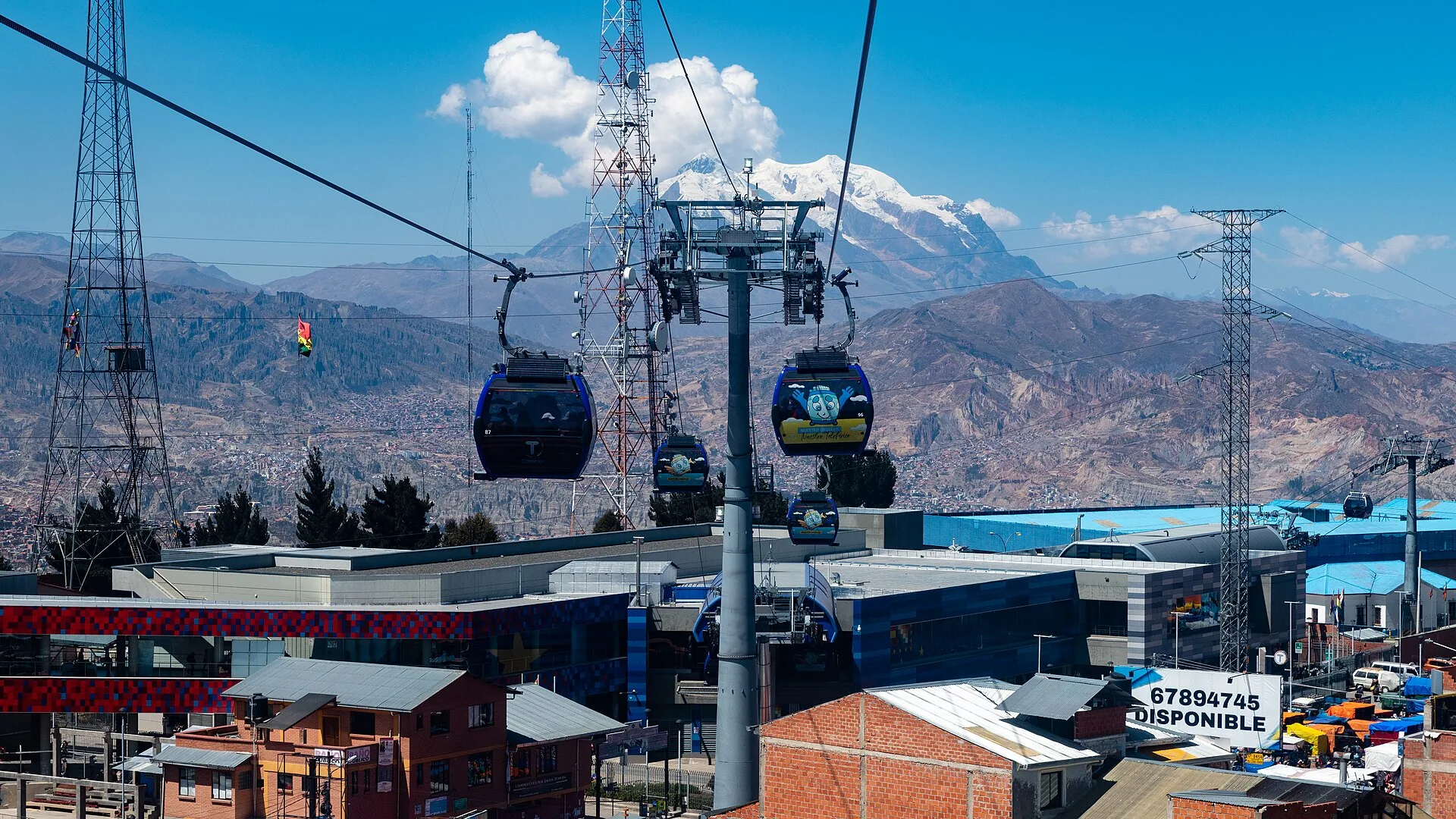 Cable cars crossing La Paz below Mount Illimani